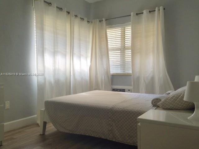 1325 Meridian Ave Unit 6, Miami Beach, FL 33139 - bedroom with baseboards and wood finished floors