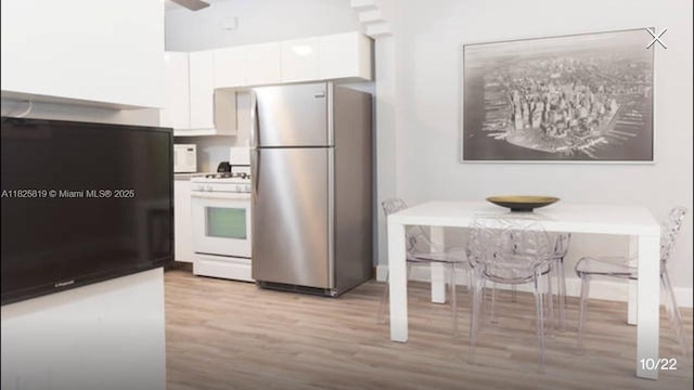1325 Meridian Ave Unit 6, Miami Beach, FL 33139 - kitchen with freestanding refrigerator, gas range gas stove, light wood-style flooring, white cabinetry, and a ceiling fan