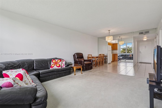 900 Saint Charles Pl Unit 420, Pembroke Pines, FL 33026 - living area featuring light colored carpet, a chandelier, light tile patterned flooring, and a textured ceiling