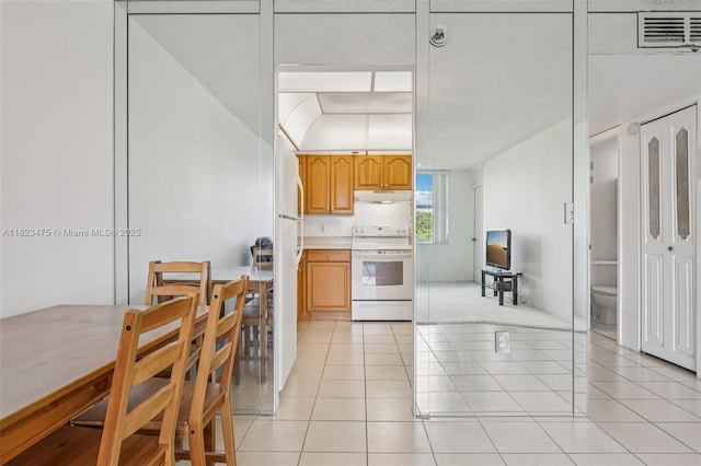 900 Saint Charles Pl Unit 420, Pembroke Pines, FL 33026 - kitchen with white range with electric stovetop, light countertops, light tile patterned floors, and under cabinet range hood