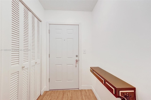 1750 NE 191st St Unit 106-1, Miami, FL 33179 - doorway to outside featuring light wood finished floors and baseboards
