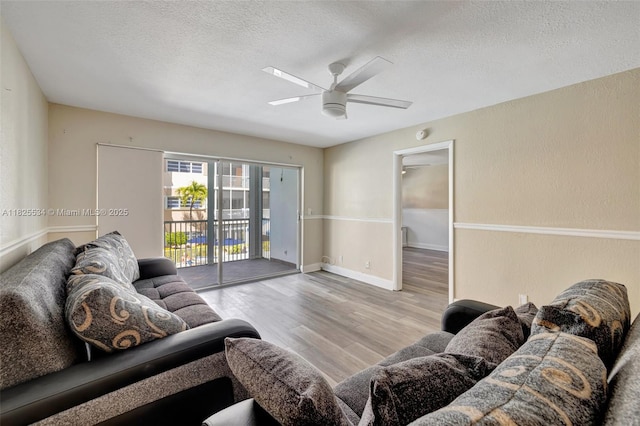 2097 S Ocean Unit 207, Hallandale Beach, FL 33009 - living area featuring a textured ceiling, a ceiling fan, and wood finished floors