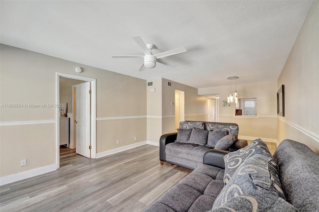 2097 S Ocean Unit 207, Hallandale Beach, FL 33009 - living room with light wood-type flooring, ceiling fan, and a textured ceiling