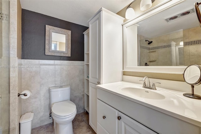 2097 S Ocean Unit 207, Hallandale Beach, FL 33009 - bathroom featuring tile walls, vanity, tile patterned flooring, and tiled shower
