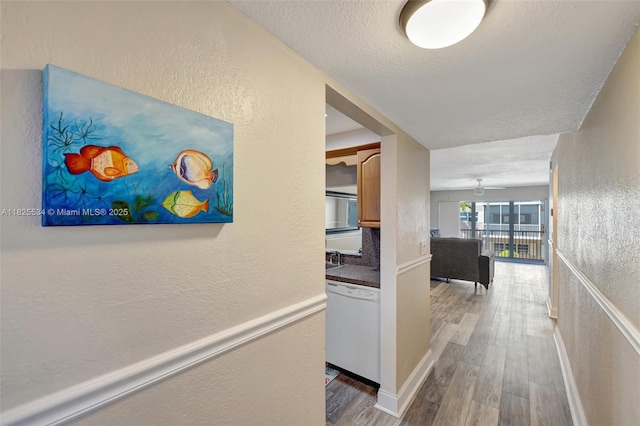 2097 S Ocean Unit 207, Hallandale Beach, FL 33009 - hall with a textured wall, wood finished floors, and a textured ceiling
