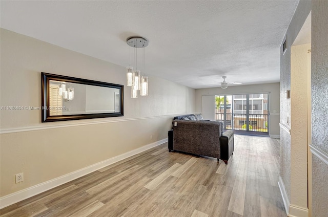 2097 S Ocean Unit 207, Hallandale Beach, FL 33009 - living room featuring wood finished floors, ceiling fan, and a textured ceiling