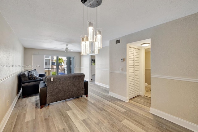 2097 S Ocean Unit 207, Hallandale Beach, FL 33009 - living area with a textured wall, ceiling fan, wood finished floors, and a textured ceiling