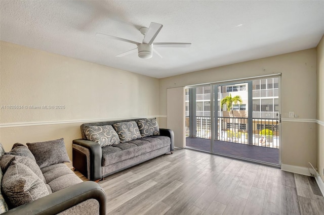 2097 S Ocean Unit 207, Hallandale Beach, FL 33009 - living room with wood finished floors, ceiling fan, and a textured ceiling