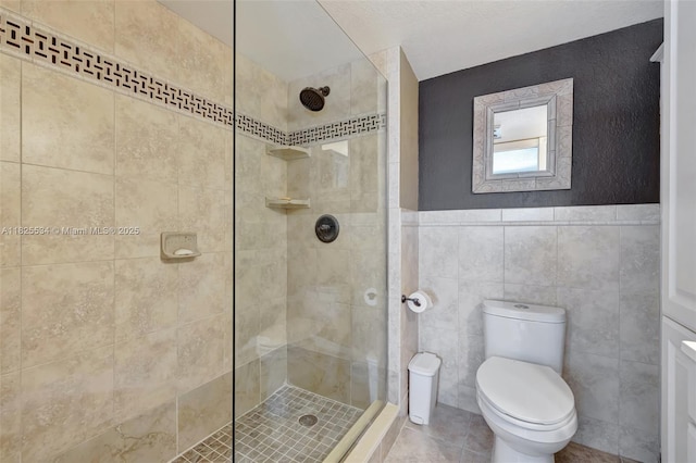 2097 S Ocean Unit 207, Hallandale Beach, FL 33009 - full bathroom featuring a shower stall, tile walls, and tile patterned flooring