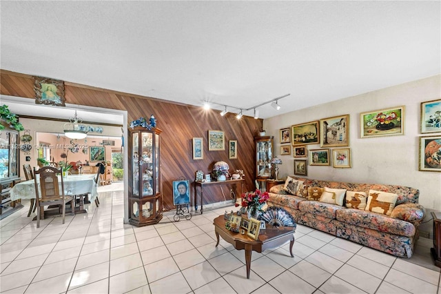 3820 SW 122nd Ave, Miami, FL 33175 - living room with wood walls, healthy amount of natural light, light tile patterned floors, and rail lighting