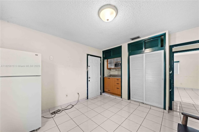 3820 SW 122nd Ave, Miami, FL 33175 - unfurnished bedroom with freestanding refrigerator, a textured ceiling, and two closets