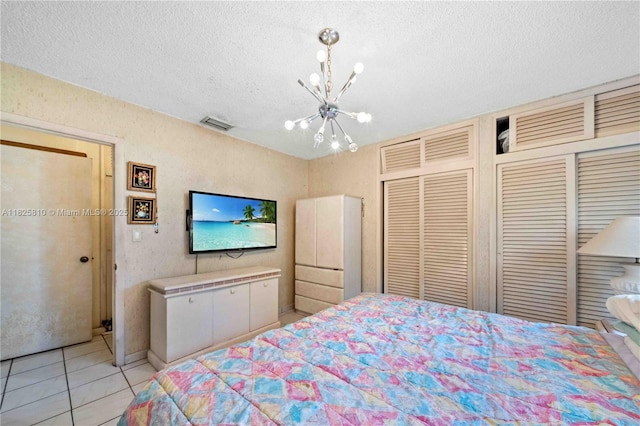 3820 SW 122nd Ave, Miami, FL 33175 - bedroom featuring a chandelier, a textured ceiling, light tile patterned floors, and a closet
