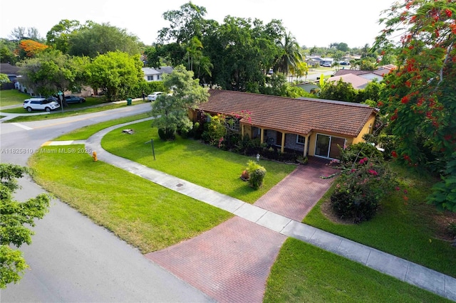 3820 SW 122nd Ave, Miami, FL 33175 - ranch-style house featuring a tiled roof, a front yard, decorative driveway, and a residential view
