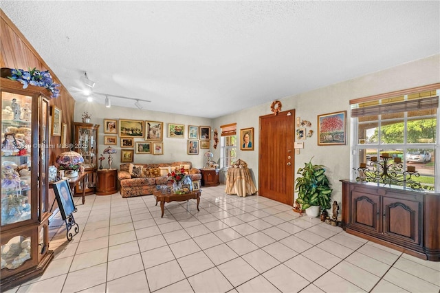 3820 SW 122nd Ave, Miami, FL 33175 - living room featuring a textured ceiling, rail lighting, plenty of natural light, and light tile patterned floors