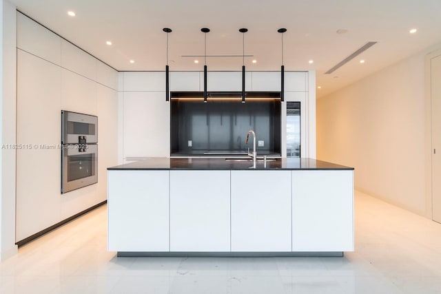 300 Biscayne Blvd Way Unit 3902, Miami, FL 33131 - kitchen featuring modern cabinets, dark countertops, stainless steel double oven, white cabinetry, and an island with sink