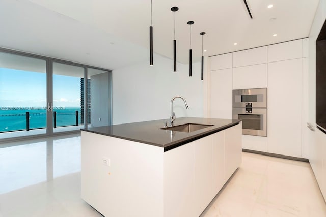 300 Biscayne Blvd Way Unit 3902, Miami, FL 33131 - kitchen featuring modern cabinets, dark countertops, white cabinets, hanging light fixtures, and floor to ceiling windows
