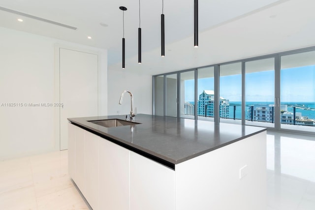 300 Biscayne Blvd Way Unit 3902, Miami, FL 33131 - kitchen with modern cabinets, a center island with sink, floor to ceiling windows, decorative light fixtures, and white cabinets