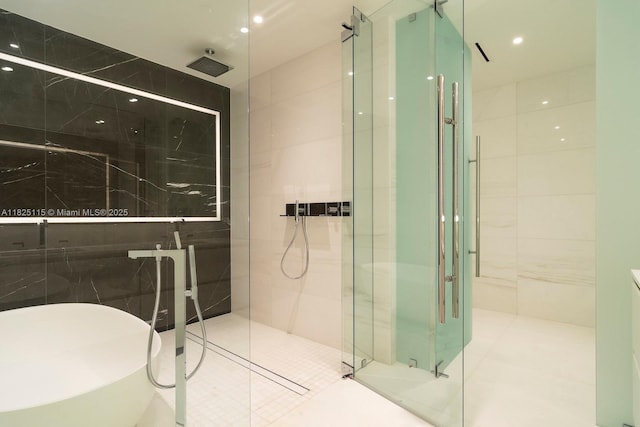 300 Biscayne Blvd Way Unit 3902, Miami, FL 33131 - full bathroom with tile walls, a shower stall, and a freestanding tub