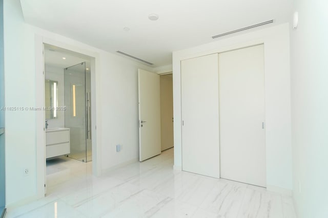 300 Biscayne Blvd Way Unit 3902, Miami, FL 33131 - unfurnished bedroom featuring a closet, light marble finish flooring, and ensuite bathroom