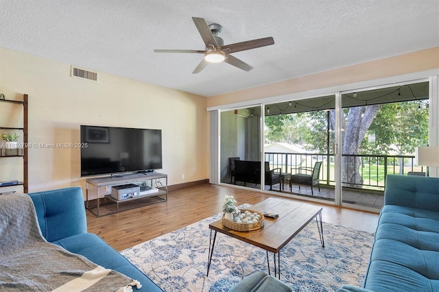 3660 Citrus Trce Unit 4, Davie, FL 33328 - living room with a ceiling fan, a textured ceiling, and wood finished floors