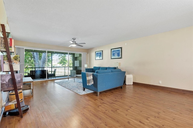 3660 Citrus Trce Unit 4, Davie, FL 33328 - living area featuring light wood-type flooring, a textured ceiling, and ceiling fan