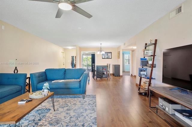 3660 Citrus Trce Unit 4, Davie, FL 33328 - living area featuring wood finished floors, a ceiling fan, a chandelier, and a textured ceiling