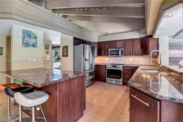 2691 SW 110th Way, Davie, FL 33328 - kitchen with appliances with stainless steel finishes, decorative backsplash, light tile patterned floors, and dark stone countertops