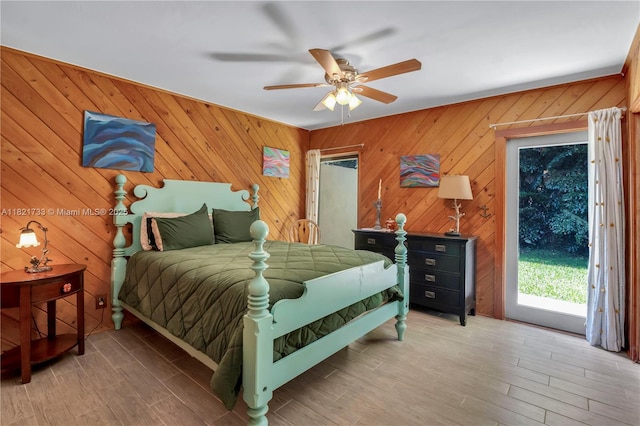 2691 SW 110th Way, Davie, FL 33328 - bedroom with wood finished floors, ceiling fan, access to outside, and wood walls