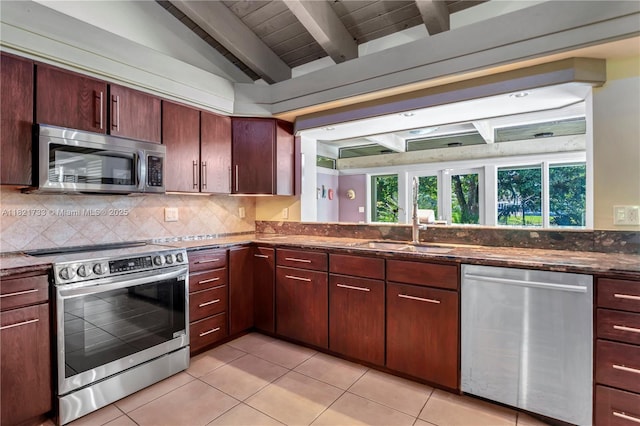 2691 SW 110th Way, Davie, FL 33328 - kitchen featuring stainless steel appliances, tasteful backsplash, light tile patterned floors, and dark stone counters