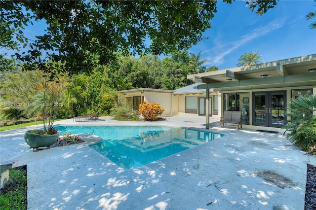 2691 SW 110th Way, Davie, FL 33328 - swimming pool with french doors and a patio