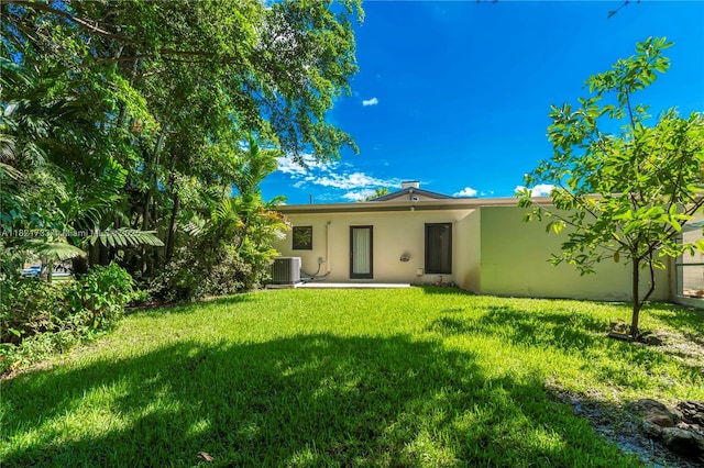 2691 SW 110th Way, Davie, FL 33328 - rear view of property featuring stucco siding and a yard