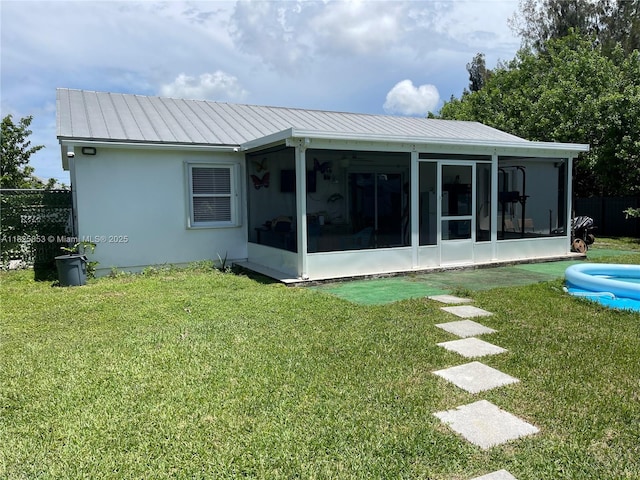 1716 SW Cordova St, Port St Lucie, FL 34987 - back of property featuring a sunroom, a standing seam roof, and a metal roof