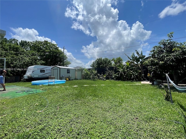1716 SW Cordova St, Port St Lucie, FL 34987 - view of grassy yard featuring a storage unit