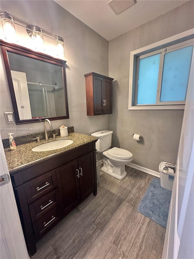 349 Mahogany Dr, Key Largo, FL 33037 - bathroom with wood finished floors, a textured ceiling, vanity, and a stall shower