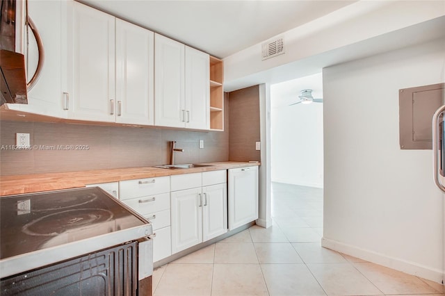 9500 W Bay Harbor Dr Unit 7H, Bay Harbor Islands, FL 33154 - kitchen featuring electric stove, tasteful backsplash, white cabinets, and light tile patterned floors