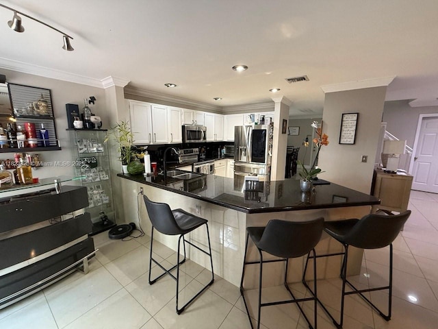 4280 NW 1st Pl, Deerfield Beach, FL 33442 - kitchen featuring appliances with stainless steel finishes, ornamental molding, a kitchen breakfast bar, light tile patterned floors, and white cabinets