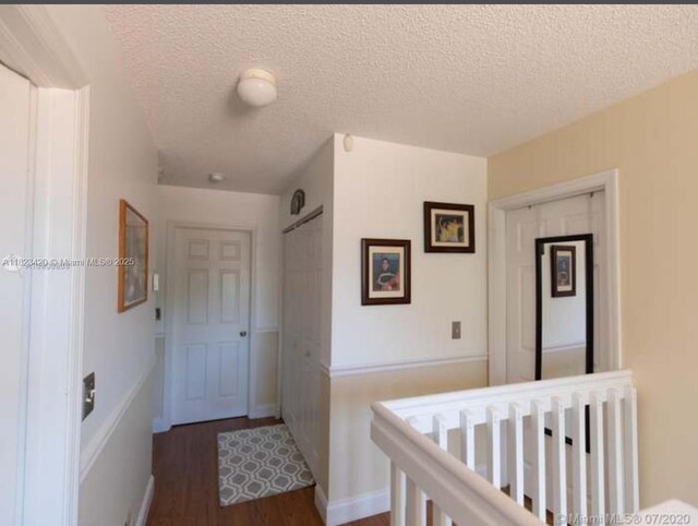 4280 NW 1st Pl, Deerfield Beach, FL 33442 - corridor featuring dark wood finished floors and a textured ceiling