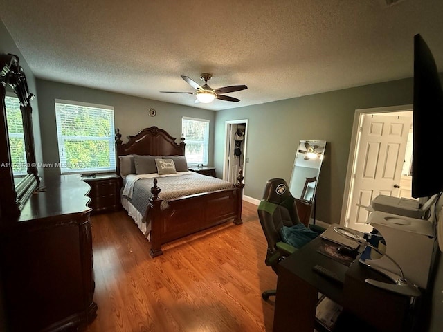 4280 NW 1st Pl, Deerfield Beach, FL 33442 - bedroom featuring a textured ceiling, light wood-style floors, and a ceiling fan