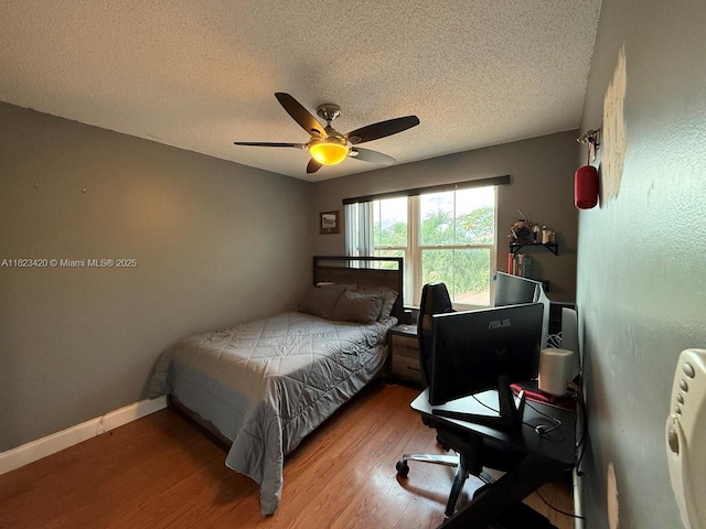4280 NW 1st Pl, Deerfield Beach, FL 33442 - bedroom featuring a textured ceiling, wood finished floors, a desk, and ceiling fan