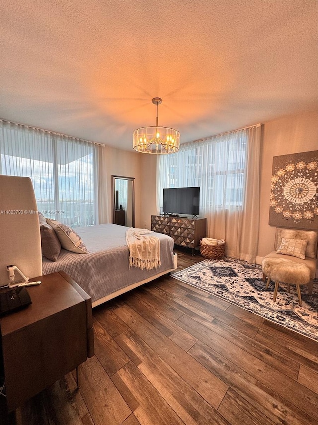 2681 N Flamingo Rd Unit 908S, Sunrise, FL 33323 - bedroom featuring a chandelier, hardwood / wood-style flooring, and a textured ceiling