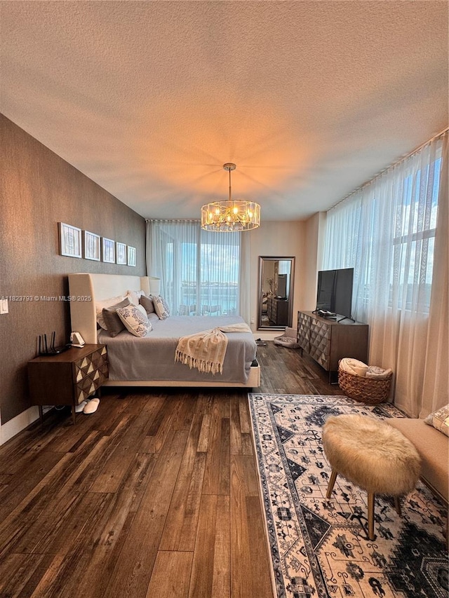 2681 N Flamingo Rd Unit 908S, Sunrise, FL 33323 - bedroom with wood-type flooring, a textured ceiling, and a chandelier