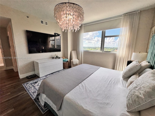 2681 N Flamingo Rd Unit 908S, Sunrise, FL 33323 - bedroom with wood finished floors, a textured ceiling, a chandelier, and a textured wall