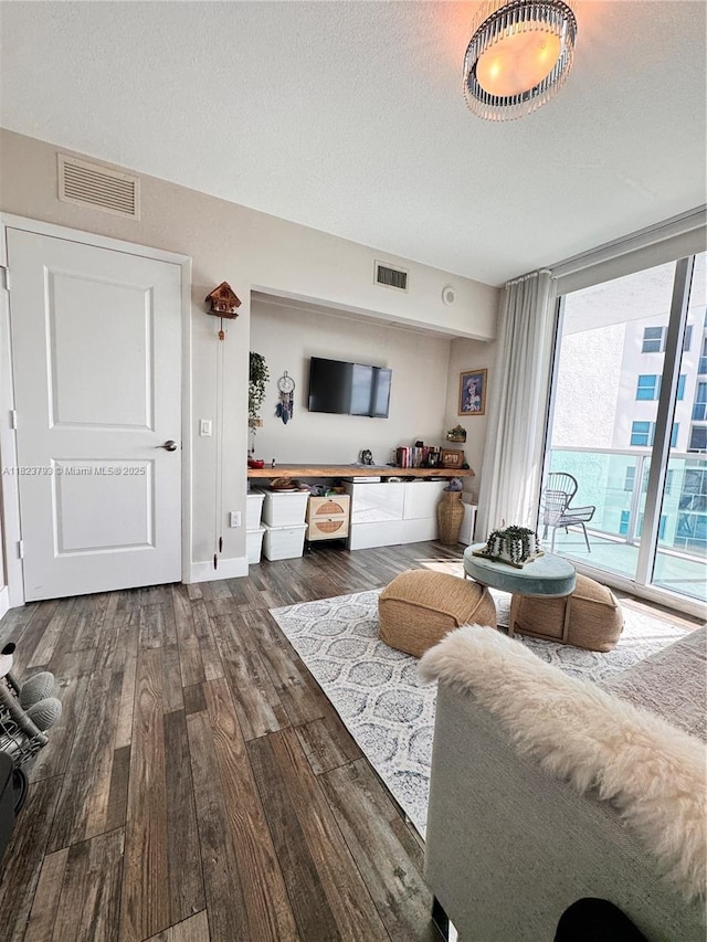 2681 N Flamingo Rd Unit 908S, Sunrise, FL 33323 - living area featuring wood finished floors, a textured ceiling, and expansive windows