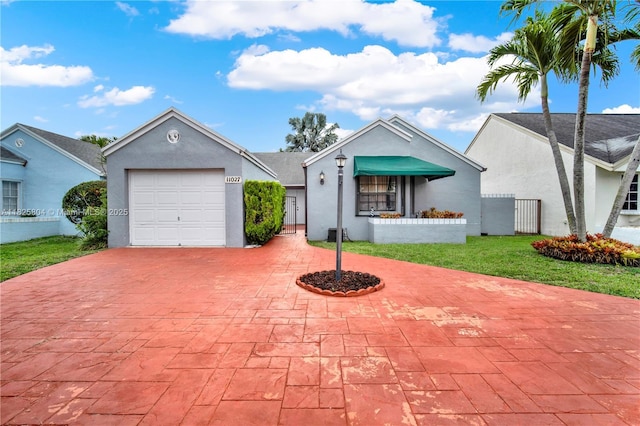 11027 SW 148th Ct, Miami, FL 33196 - ranch-style house with decorative driveway, stucco siding, and an attached garage