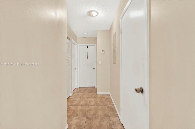 11027 SW 148th Ct, Miami, FL 33196 - hallway with light tile patterned floors and a textured ceiling
