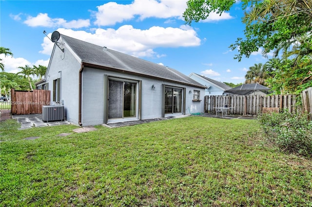 11027 SW 148th Ct, Miami, FL 33196 - rear view of house with stucco siding, a fenced backyard, and a shingled roof