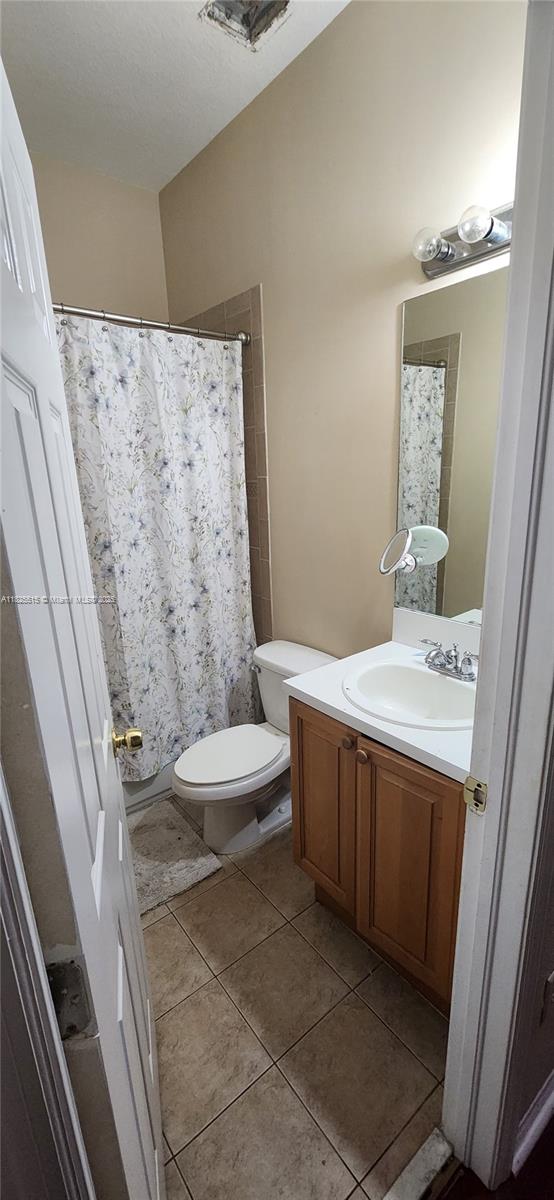 14111 SW 49th St Unit 8, Miramar, FL 33027 - full bathroom featuring vanity, tile patterned flooring, and curtained shower