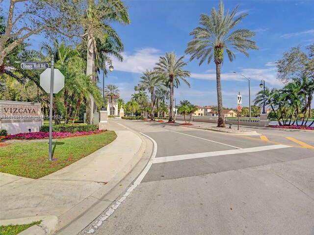 14111 SW 49th St Unit 8, Miramar, FL 33027 - view of asphalt street with sidewalks, street lights, curbs, and traffic signs