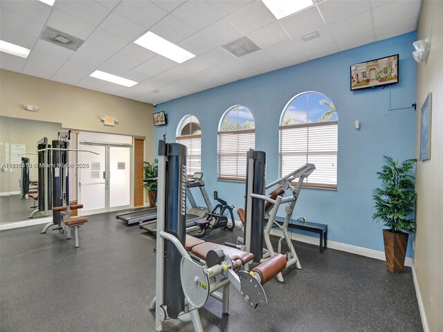 14111 SW 49th St Unit 8, Miramar, FL 33027 - workout area featuring a drop ceiling and baseboards