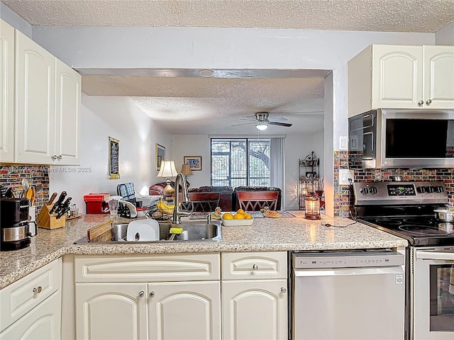 8635 NW 8th St Unit 103, Miami, FL 33126 - kitchen with stainless steel appliances, a textured ceiling, a peninsula, tasteful backsplash, and a ceiling fan